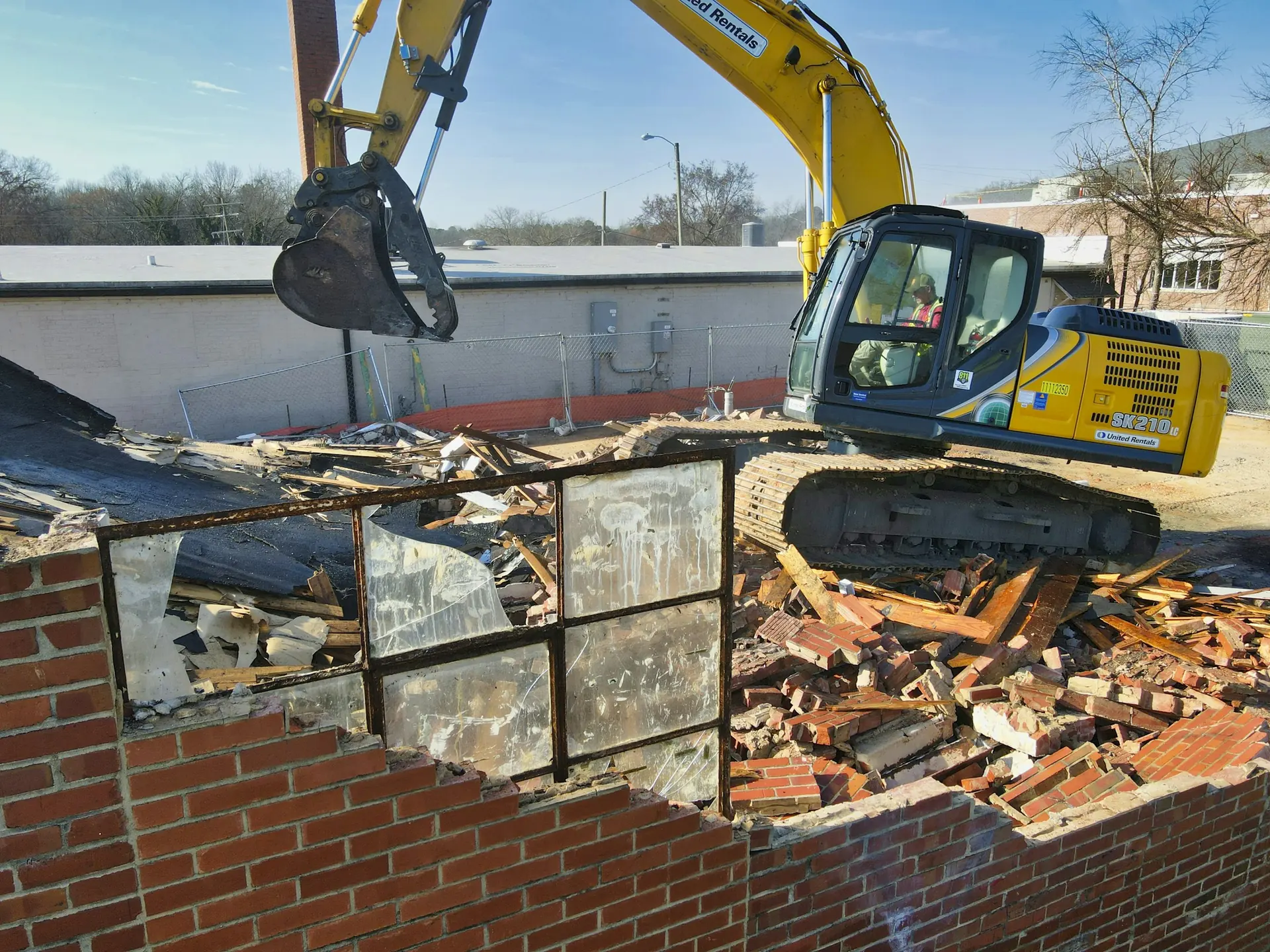 Demolition with a long-reach excavator