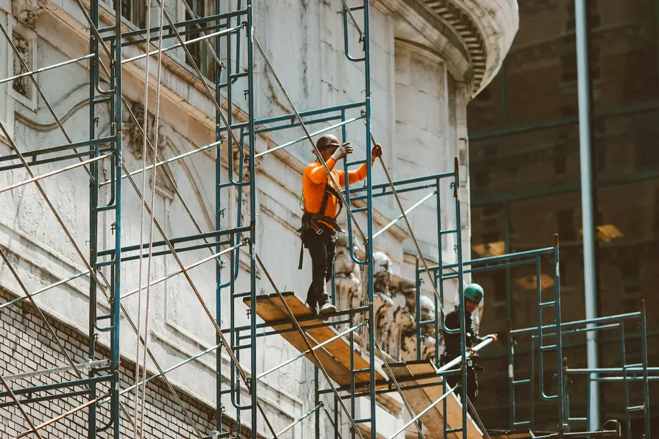 Scaffolder climbing a scaffold tower